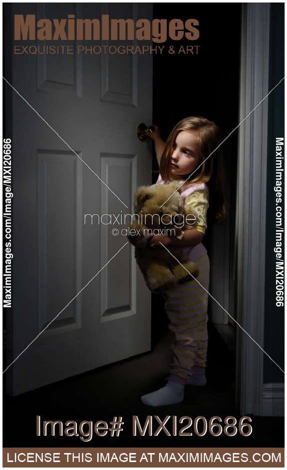 little-girl-looking-out-of-a-room-at-night-stock-image-CFFF.jpg